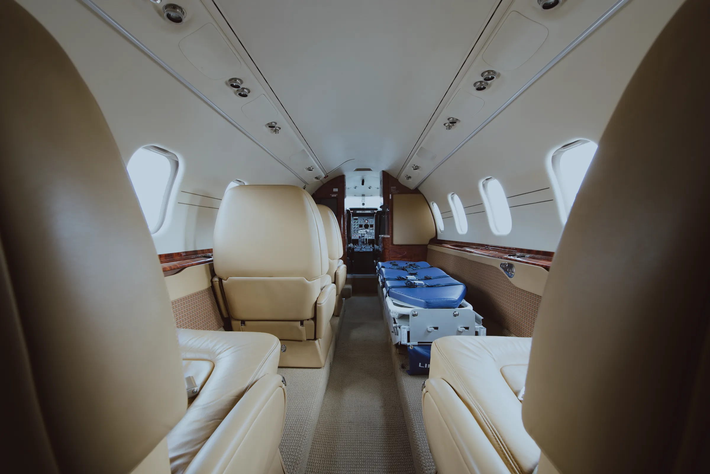 The jet's cabin looking forward, stretcher along the left side and the cockpit beyond. (their own photograph)