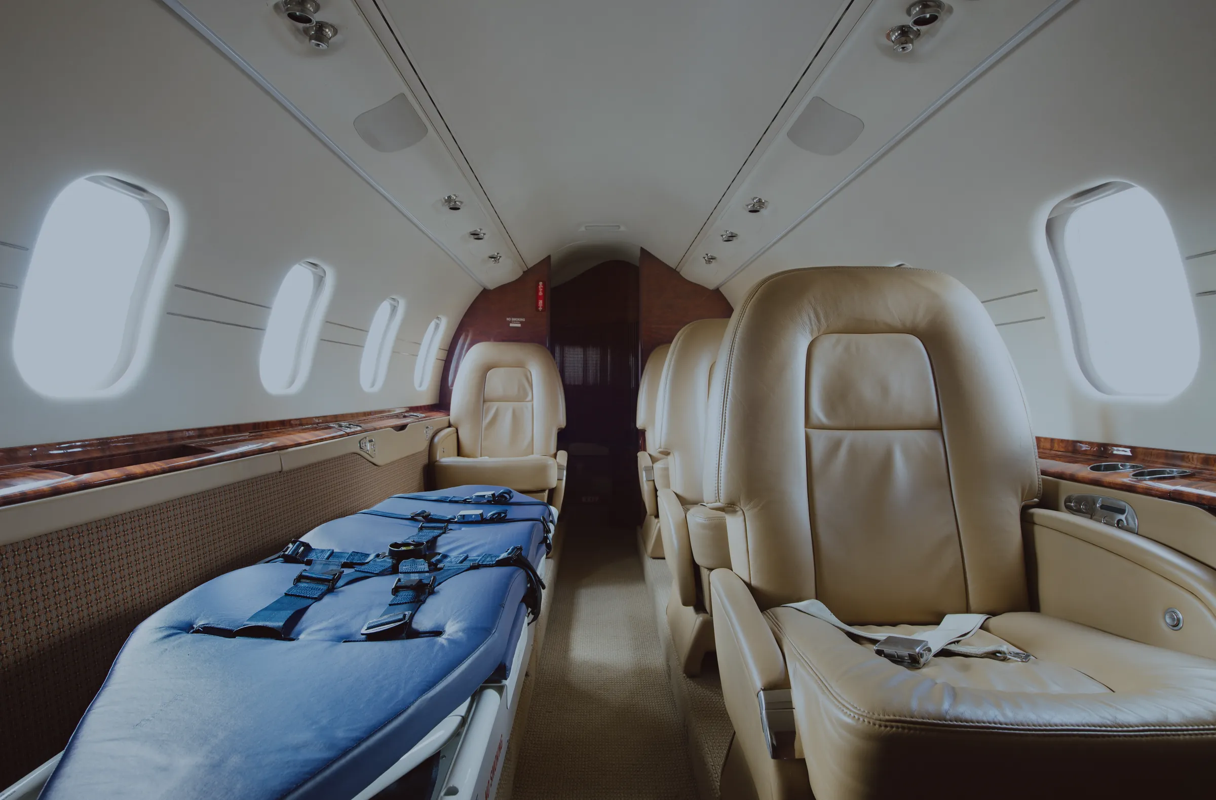 A stretcher secured in the cabin beside a leather seat, ready for a patient. (their own photograph)