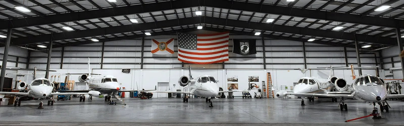 The Jet ICU hangar: Learjets under the lights, the U.S., Florida and POW flags on the back wall. (their own photograph)