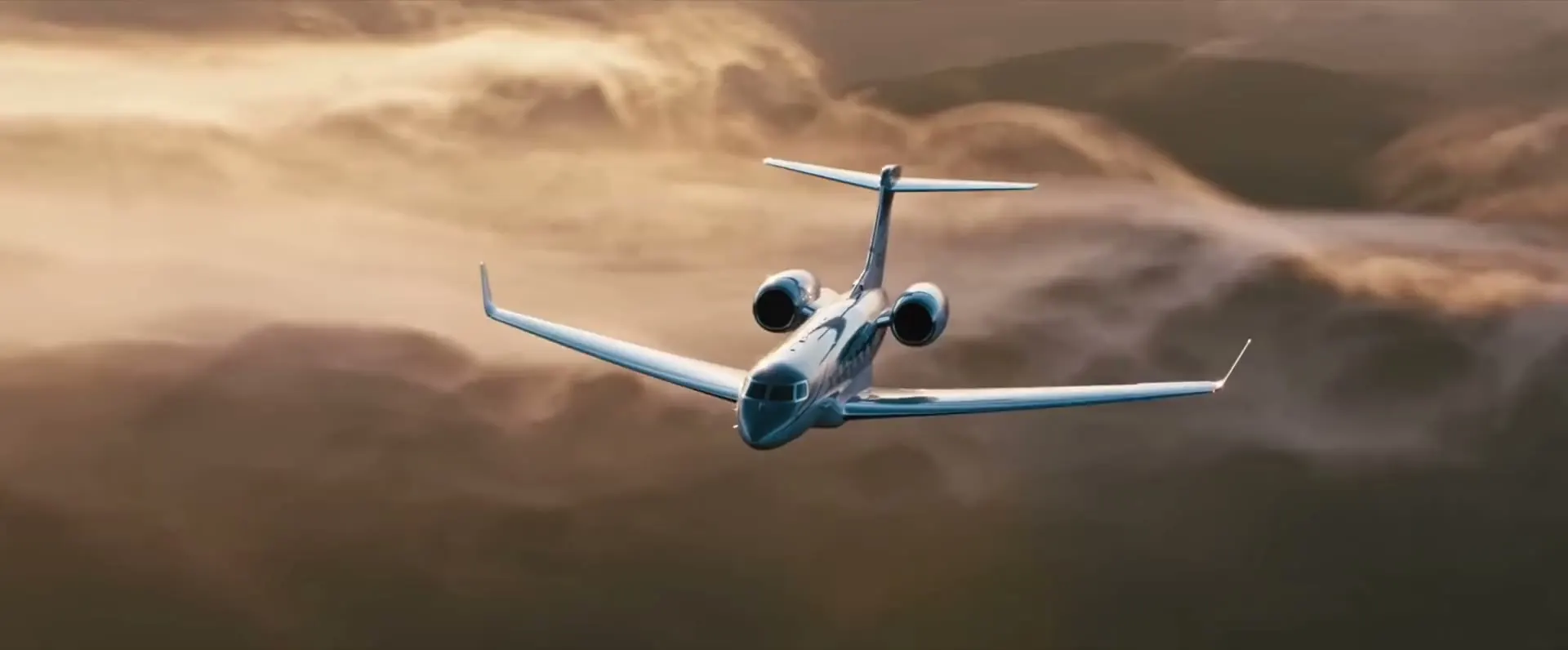 A business jet flying above the clouds at golden hour (stock footage).