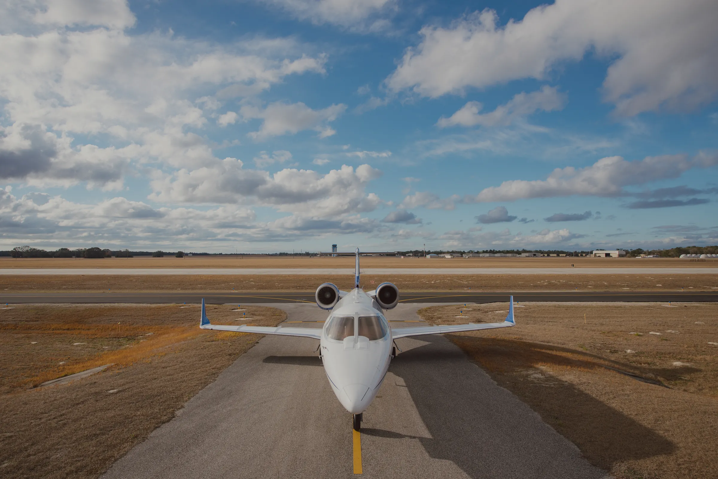A Jet ICU Learjet lined up on the runway, nose toward the camera. (their own photograph)